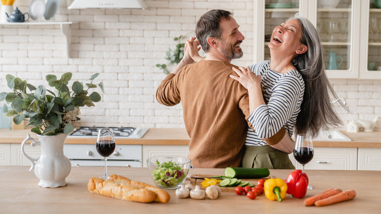 man and woman dancing in kitchen