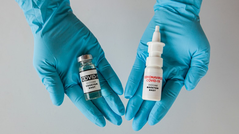 a person holding nasal spray and the COVIC-19 vaccine