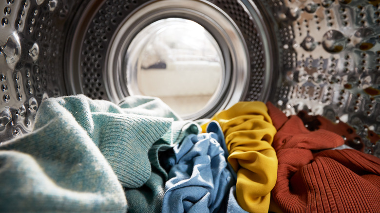 Inside of a washing machine filled with clothes