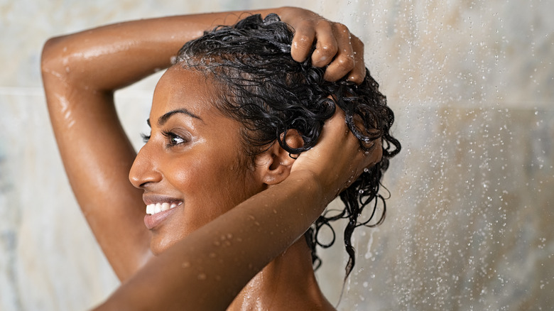 Woman washing and conditioning hair