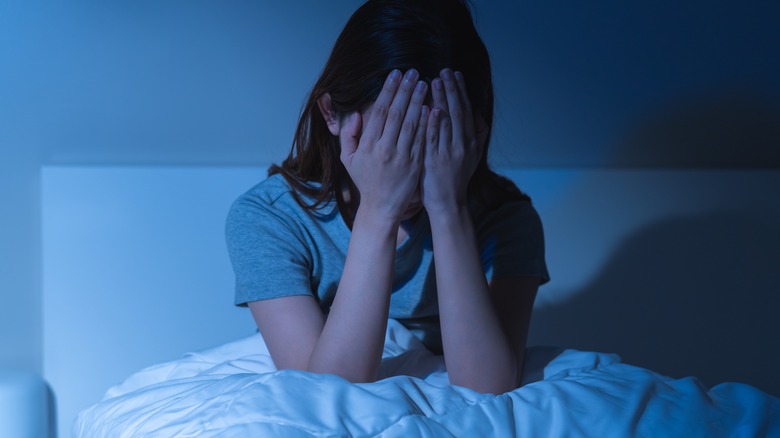 anxious woman in bed