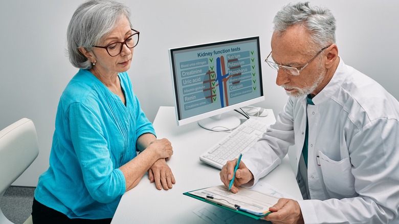 older woman talking with doctor about kidneys