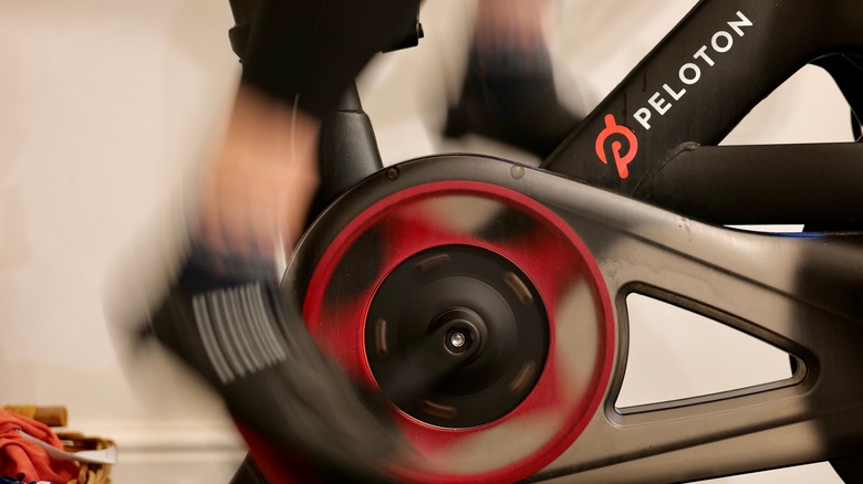 Feet pedaling on a Peloton bike