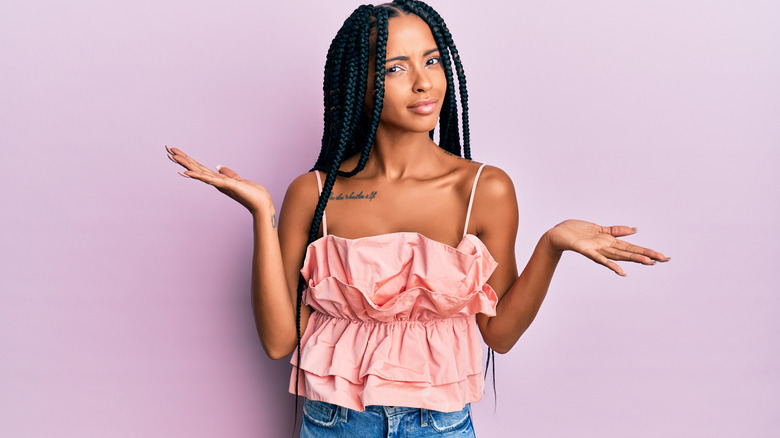 Young woman shrugging