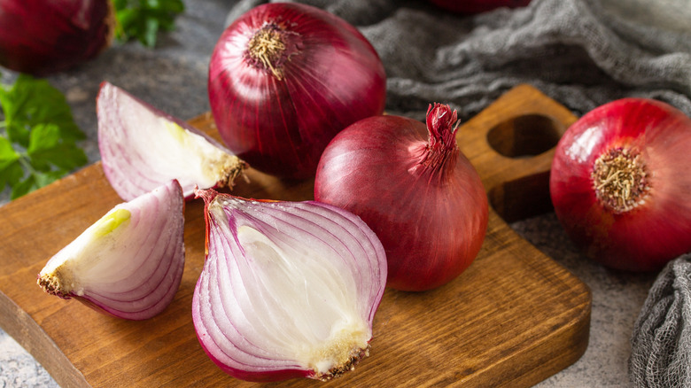 Raw onions on cutting board