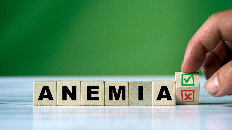 Wooden blocks spelling out "anemia" and a hand