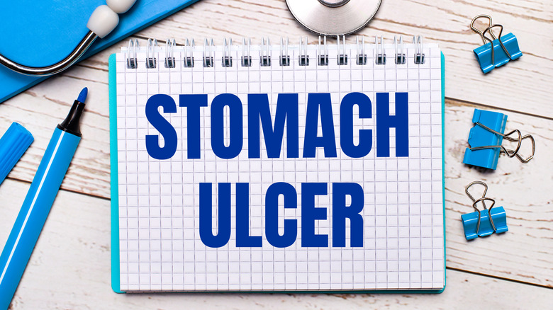 Notepad that says "Stomach Ulcer" by stethoscope