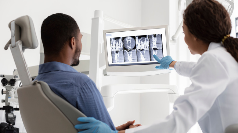 Dentist showing x-rays to a patient