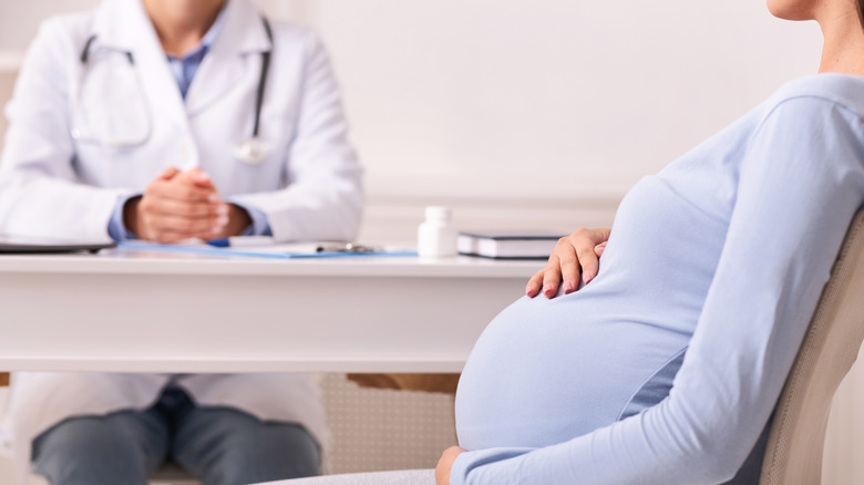 Woman talking with doctor about medication in office