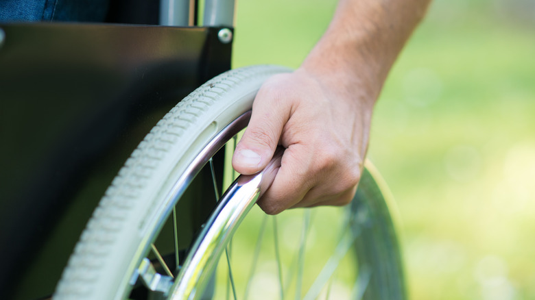 close-up of a man's hand on a wheelchair