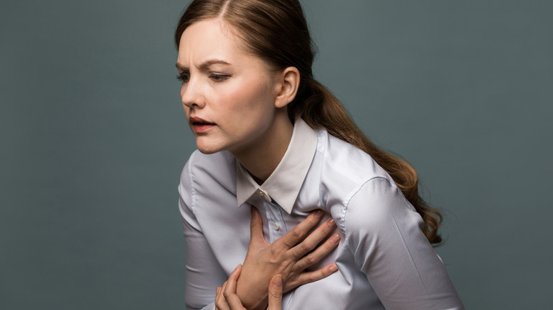 woman holding chest