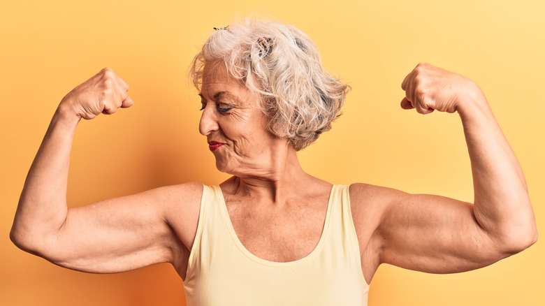 older woman flexing muscles