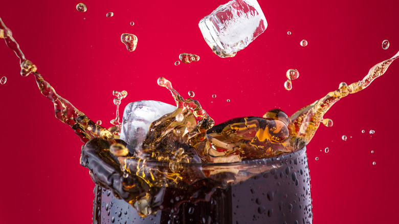 ice cubes splashing into soda