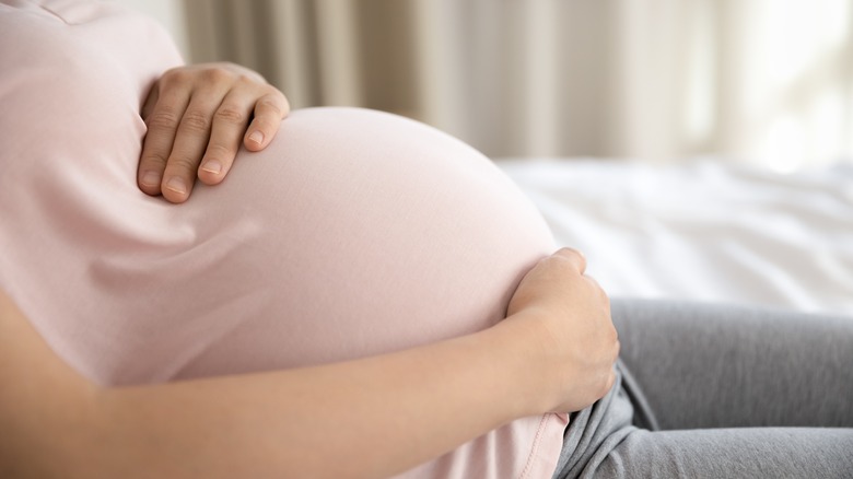 pregnant woman holding belly