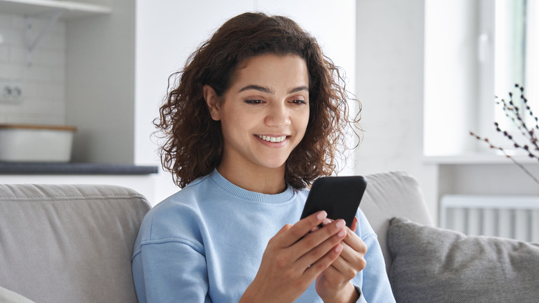 teen smiling while on phone