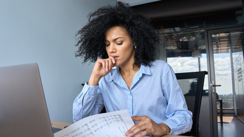 Frustrated woman looks at reports