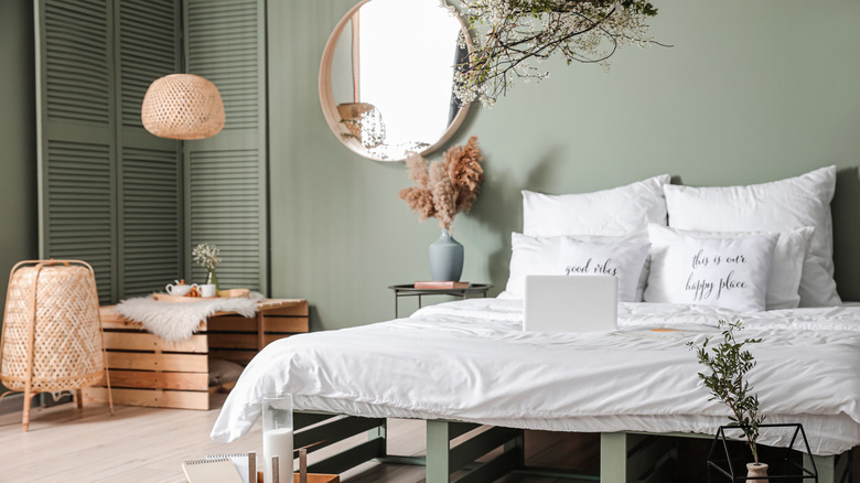bohemian bedroom with sage green wall