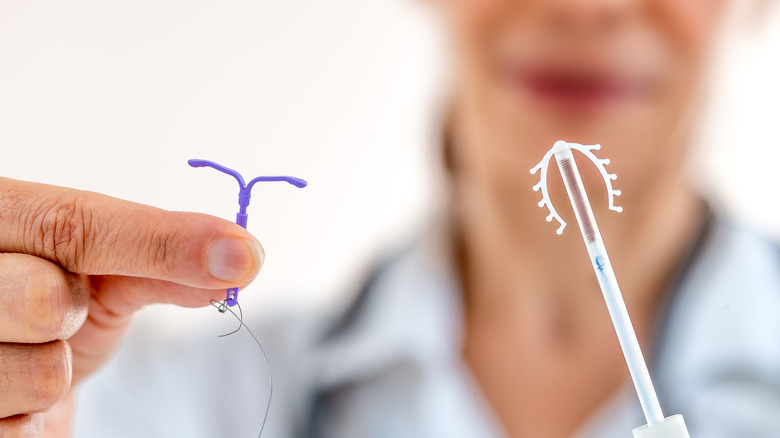 Doctor holding IUD