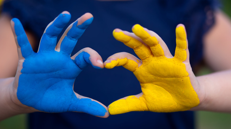 hands painted in Ukrainian colors