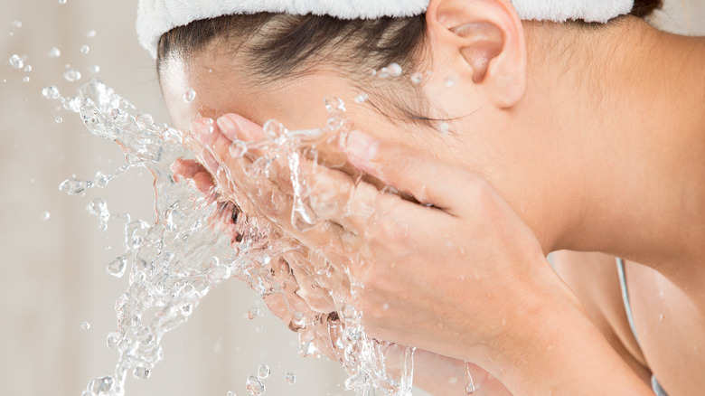 Woman washing her face