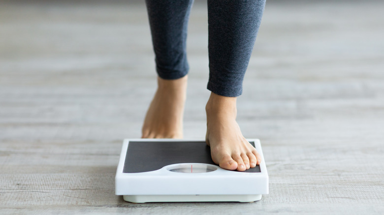 Woman on weighing scale