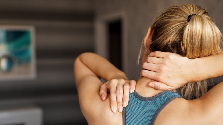 Woman in sports bra with neck pain