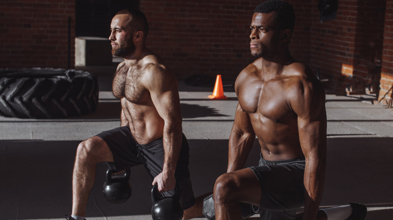 Two men competing with kettlebells