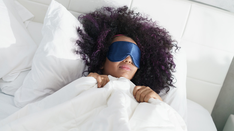 Woman asleep in daylight with eye mask on