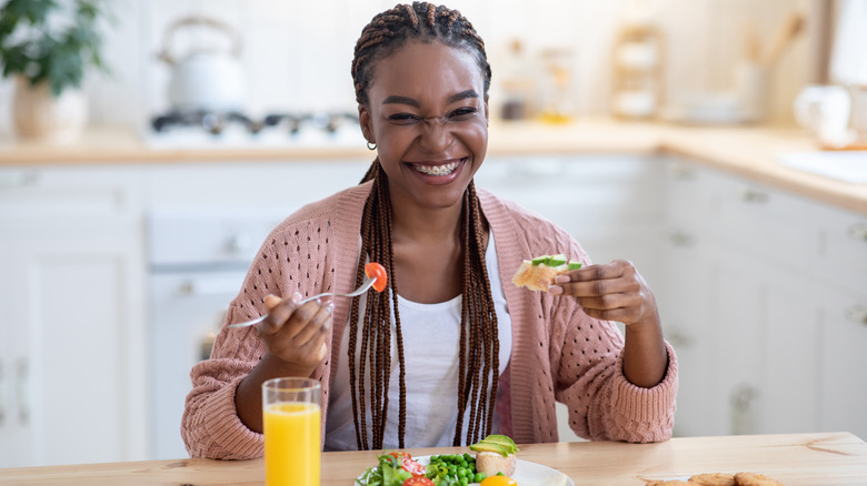 Black woman eating breakfast