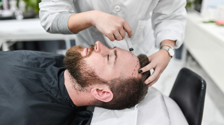 man receiving hair transplant