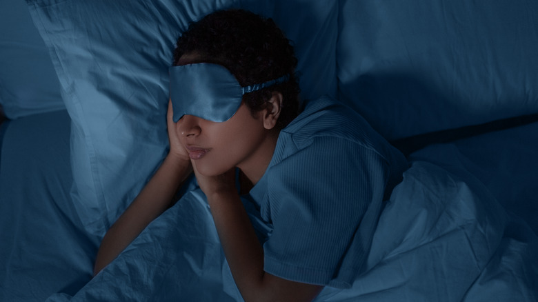 Woman asleep wearing sleep mask