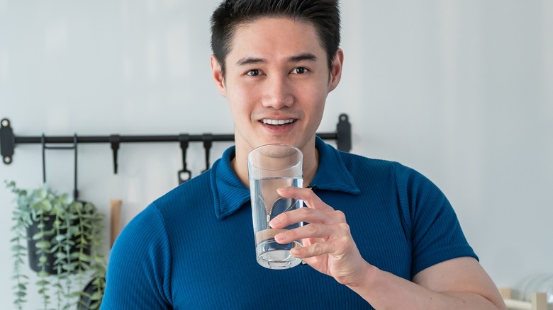 man holding glass of water