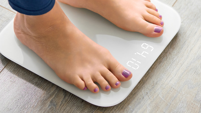 pedicured feet on weighing scale