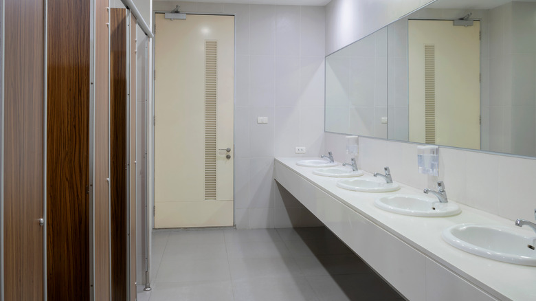 sinks and stalls in clean restroom