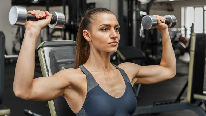 Woman doing shoulder press with weights