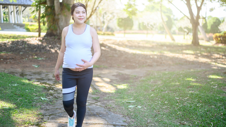 pregnant woman walking outside 