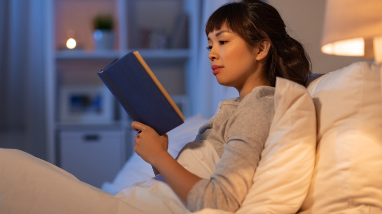 woman reading in bed