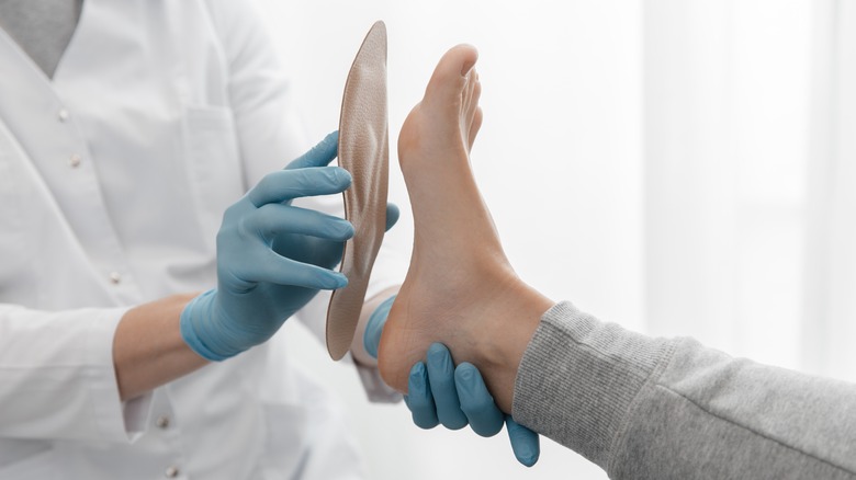 foot being fitted for an orthotic