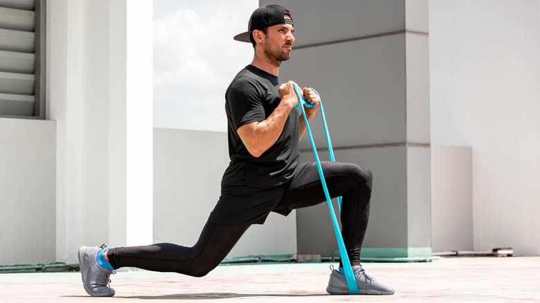 man working out with resistance bands to rehab from tendinitis