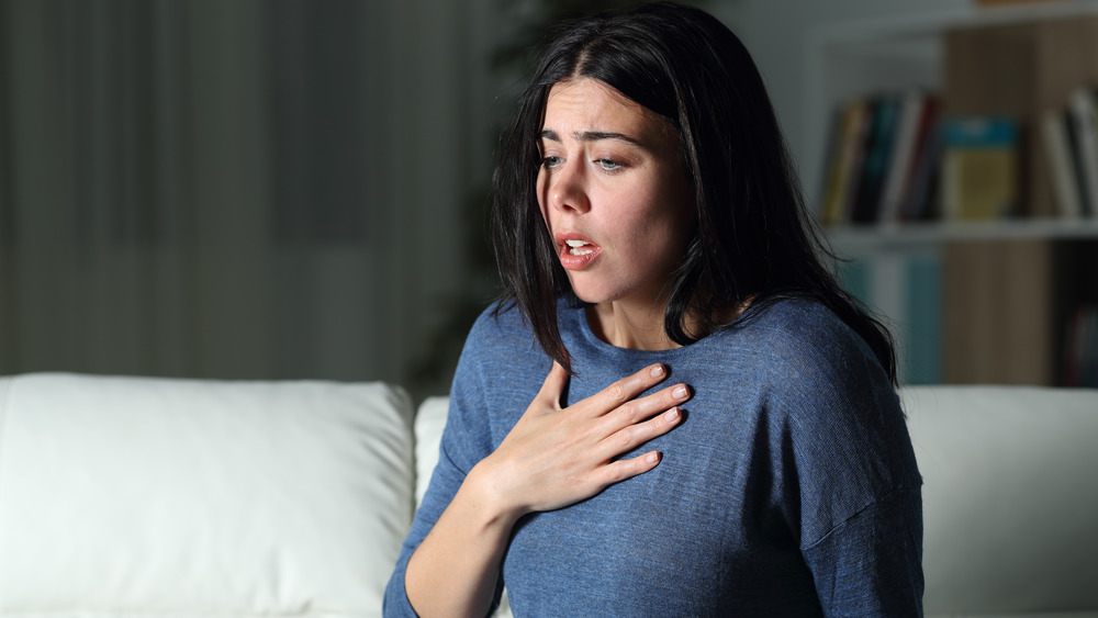 Scared woman clutching chest
