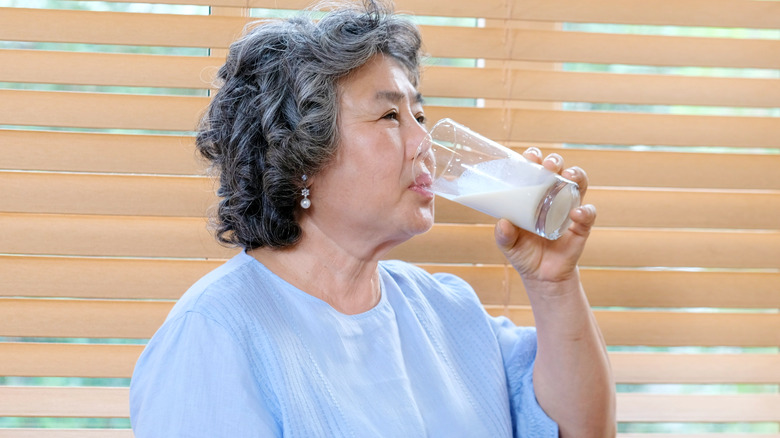 older woman drinking milk