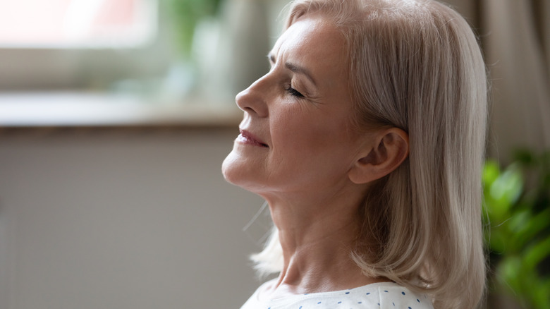 older woman breathing deep