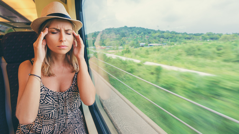 woman sitting window train