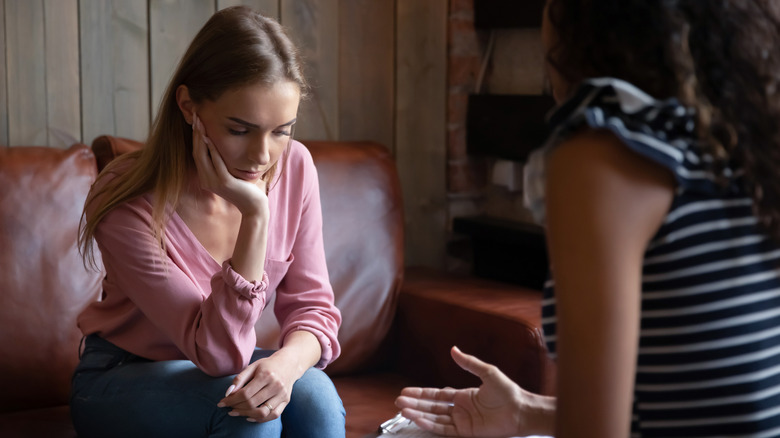 young woman looking upset during therapy session