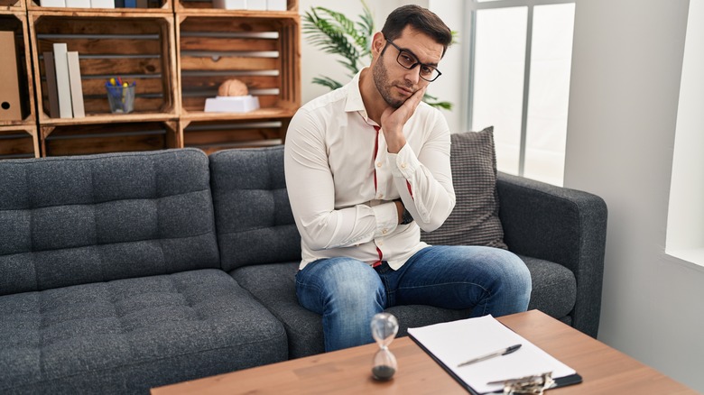 therapist sitting on a couch looking bored