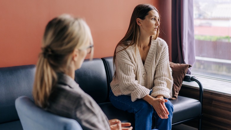 woman in therapy, looking away from her therapist