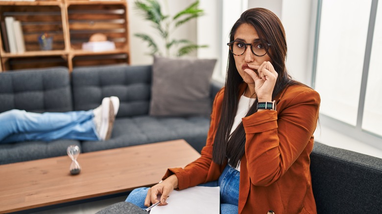 female therapist holding her lips shut