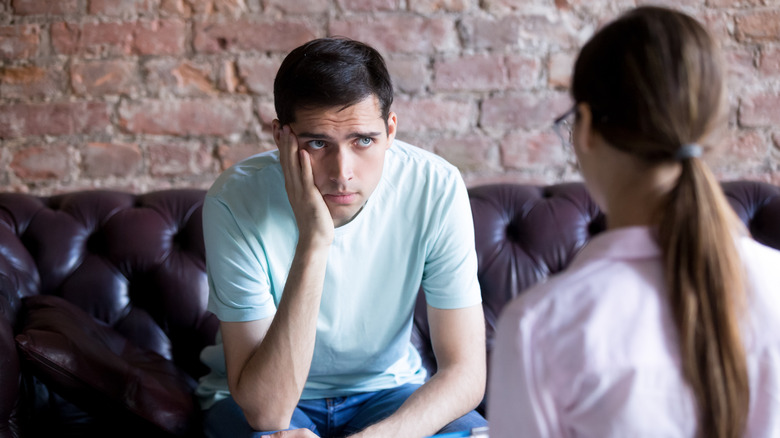 upset man looking at his therapist