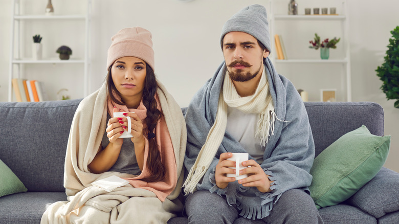 man and woman holding tea