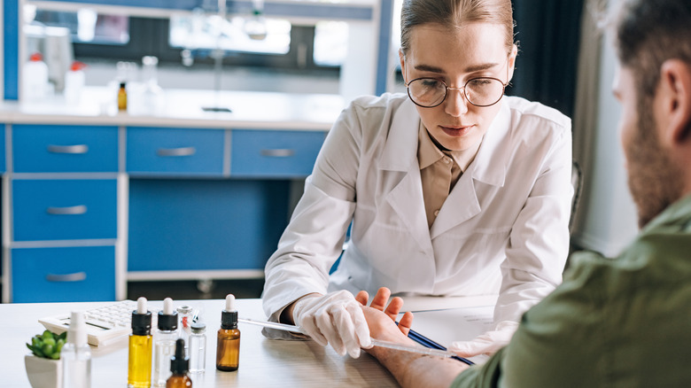 Allergist examining patient's arm